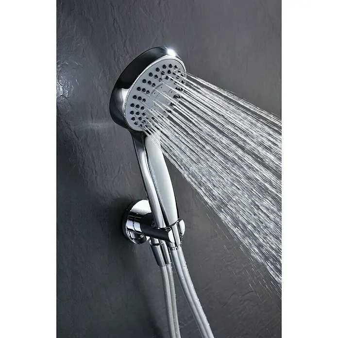 Imex Sistema de ducha empotrado Oslo - Cromo - Primer plano de un cabezal de ducha cromado con chorros de agua que salen, montado en una pared gris. El diseño elegante mejora cualquier baño.