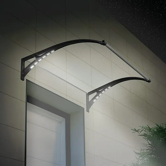 SmartSun Marquesina para puerta Easy LED - 120 x 97 x 31,6 cm, Antracita - Toldo exterior negro con dosel transparente y luces LED integradas que iluminan una entrada por la noche.