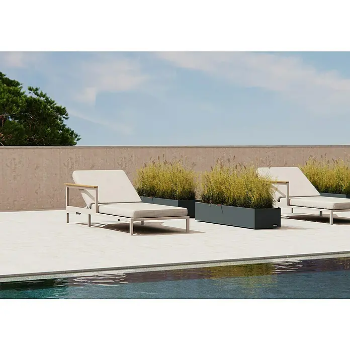 Herstera Garden Pflanzkasten Cube - Außenmaß (L x B x H): 150 x 40 x 25 cm, Metall, Anthrazit - Helle Outdoor-Liegestühle und dunkle Pflanzgefäße mit hohem Gras am Pool.