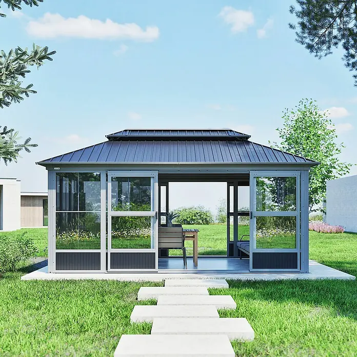 Sojag Standard-Pavillon Olan 1017 - Grau, Schwarz, Metall, L x B x H: 310 x 529,5 x 291 cm - Ein modernes graues Gartenhaus mit dunklem Metalldach und Glaspaneelen, auf einer Betonplatte mit Trittsteinen.