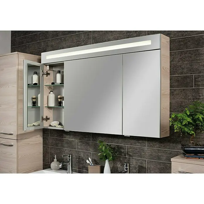 Fackelmann Oxford Badmöbel-Set - Gesamtbreite Badmöbel: 120 cm, Braun Hell, Matt, 3-Teiliges Set mit Spiegelschrank - Heller Holz-Spiegelschrank für das Bad mit integrierter LED-Beleuchtung, eine Tür offen mit Glasböden. Über einem Waschbecken montiert.