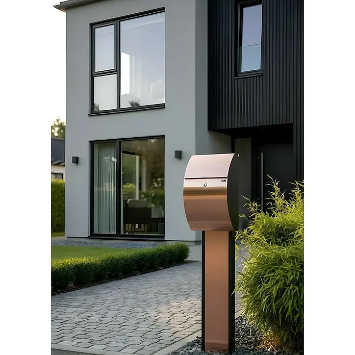 Allux Briefkasten 7000 - L x B x H: 195 x 320 x 510 mm, Kupfer / Schwarz, Stahl - Elegante, kupferfarbene Stehbriefkasten vor einem modernen Hauseingang.