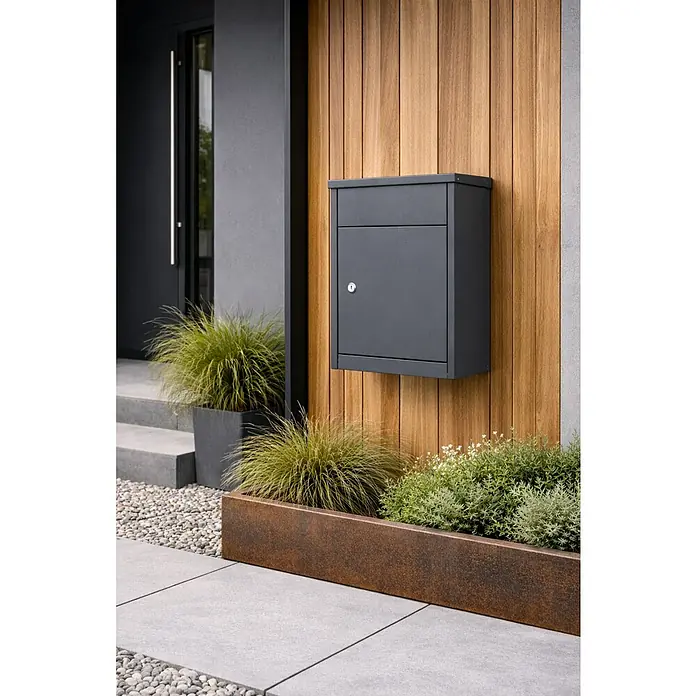 Allux Standbriefkasten 500 - L x B x H: 250 x 380 x 530 mm, Anthrazit, Stahl, Paketfach, Zylinderschloss - Dunkelgrauer Briefkasten an einer modernen Holzwand, Teil eines zeitgenössischen Hauseingangs mit Pflanzen.