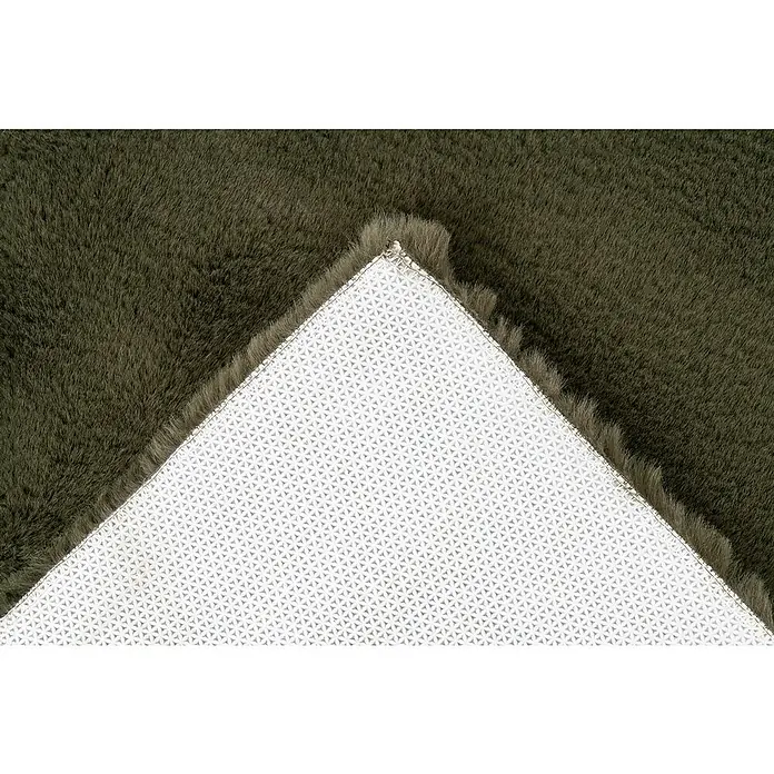 Badteppich Happy - 67 x 110 cm, Basil, 100% Polyester - Dunkelgrüner Kunstfellteppich, eine Ecke zurückgeschlagen zeigt die weiße rutschfeste Rückseite mit Sternmuster.