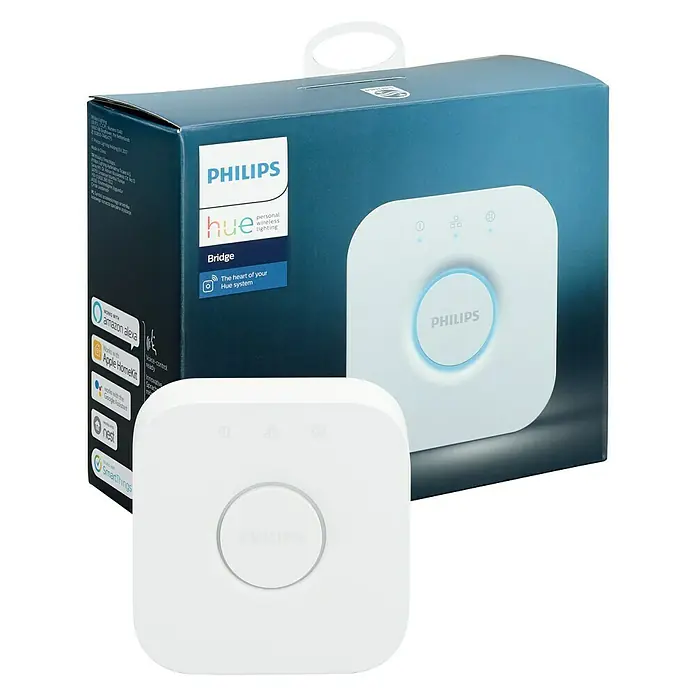 Philips Hue Centro de control Puente - Específico para: Sistema Philips Hue, L x An x Al: 2,6 x 8 x 8 cm - Primer plano de una caja Philips Hue Bridge con el Hue Bridge en primer plano, que ofrece conectividad e integración para el hogar inteligente.