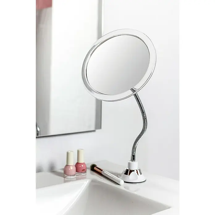 Deblanch Espejo cosmético orientable - 20 x 29,5 cm, Redonda, Blanco, Aumento 1: 300 %, Aumento 2: 700 % - Primer plano de un espejo cosmético con brazo flexible, esmalte de uñas y una brocha de maquillaje sobre un tocador blanco.
