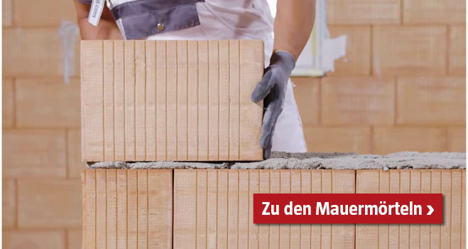 Mauerstein wird auf Mauermörtel gesetzt