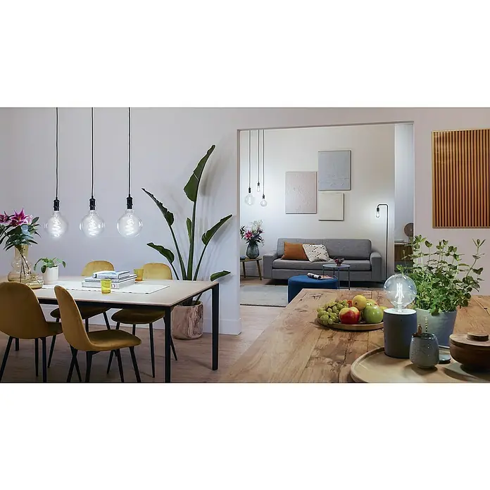 Philips Wiz Smart-LED-Lampe - E27, Dimmbar, Neutralweiß, 470 lm, 7 W, 1 Stk. - Moderne Smart-Glühbirnen mit sichtbarem Filament beleuchten einen Ess- und Wohnbereich.