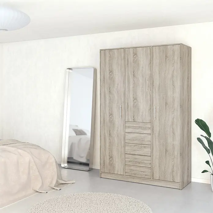 Meka Block Armario para ropa K-9235 - L x An x Al: 50 cm x 130 mm x 200 cm, Roble Cortez - Armario de madera clara con 3 puertas y 4 cajones en un dormitorio.