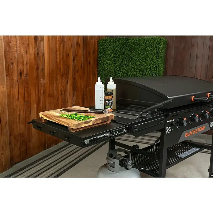 Blackstone Plancha Grill - Superficie de la parrilla (An x Pr): 91 x 55 cm, Negro, Número de quemadores: 4 ud. - Plancha Blackstone negra con estante lateral, tabla de cortar con cebollino picado, cuchillo y accesorios de cocina, lista para usar.