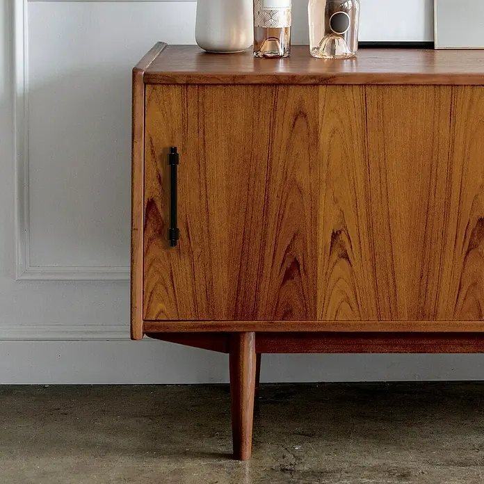 Rei Möbelgriff - Lochabstand: 96 mm, Sonstige, Schwarz, L x B x H: 127 x 14 x 39 mm - Mid-Century Modern Holzschrank mit einer Tür, schwarzem Griff und konischen Beinen, in einem Raum inszeniert.