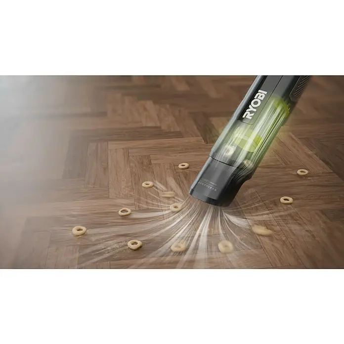 Ryobi Akku-Handstaubsauger RHV44-220G - 8 V, 2 Akkus, 2 Ah, Behältervolumen: 0,15 l - Schwarzer Ryobi Handstaubsauger mit grünem Staubbehälter saugt Schmutz von Holzfußboden, starke Saugleistung ist sichtbar.