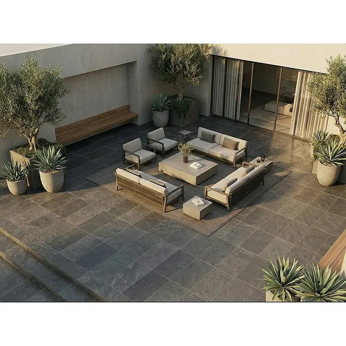 Terrassenfliese Museo Ardesia - 60 x 90 x 2 cm, Nera, Matt - Outdoor-Lounge-Set mit zwei Sofas, zwei Sesseln und Betoncouchtischen, auf einem Teppich auf einer modernen gefliesten Terrasse.