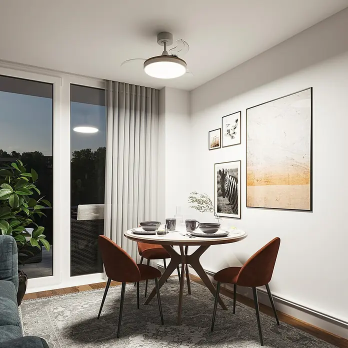 Arte confort Ventilador de techo Ginebra - Blanco, 91 cm, 28 W, Blanco cálido - Ventilador de techo blanco con aspas transparentes retráctiles y luz LED circular integrada, iluminando una mesa de comedor.