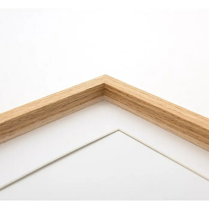 Accent Holzrahmen Objektrahmen Aura - DIN A4 / 21 x 29,7 cm, Eiche - Ecke eines hellen Holzbilderrahmen mit weißem Passepartout.