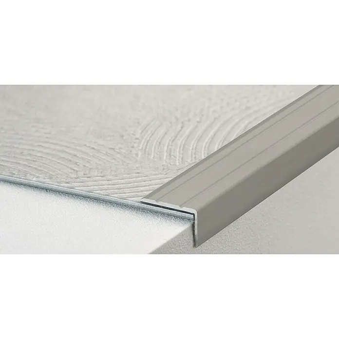 LOGOCLIC Winkelprofil 162 - Edelstahl matt, 1 m x 24,5 mm x 20 mm, Montageart: Kleben - Detailaufnahme einer Treppenkantenprofil in Silber, das stilvoll zwischen Stufe und Belag angebracht ist.