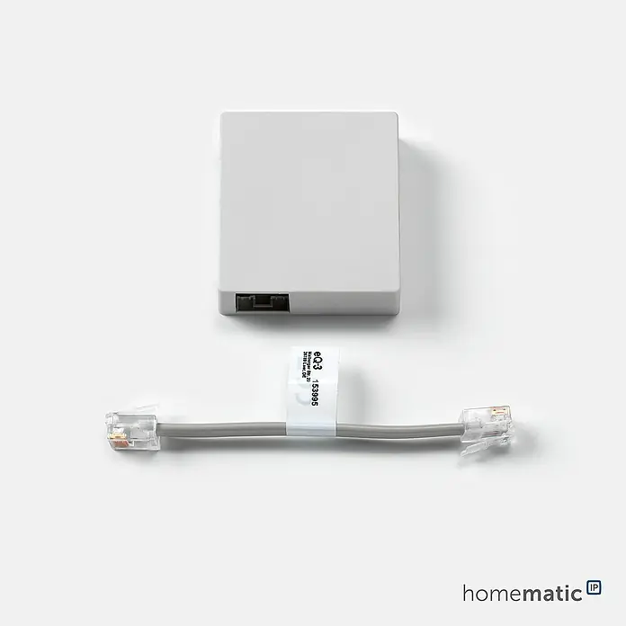 Homematic IP Funk-Schaltermodul HmIP-MOD-HO - Passend für: Hörmann-Antriebe - Hellgraue Smart Home Adapterbox mit zwei RJ11-Anschlüssen und passendem kurzem RJ11-Verbindungskabel.