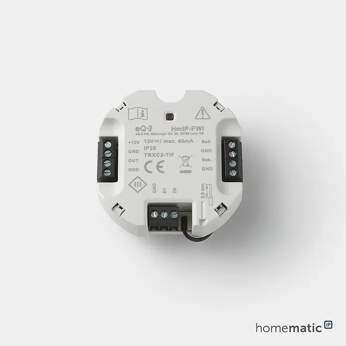 Homematic IP Funk-Schaltermodul Wiegand-Schnittstelle HmIP-FWI - Passend für: Wiegand-fähige Endgeräte - Weißes rundes Homematic IP Modul mit mehreren Schraubklemmen zur Verdrahtung, zeigt Stromeingang +12V/40mA und verschiedene Anschlüsse.