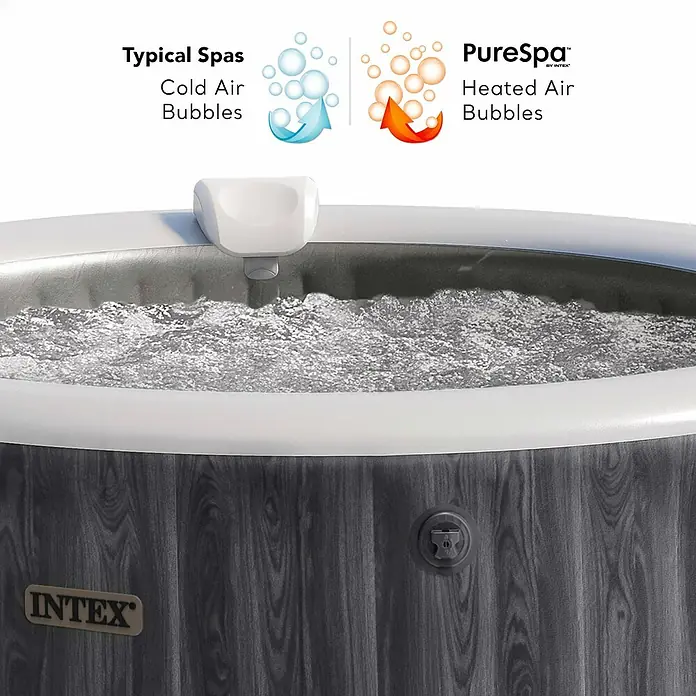 Intex Pure Spa Hidromasaje móvil Greenwood - Ø x Al: 216 x 71 cm, Gris/Blanco, 1.098 l - Jacuzzi Intex PureSpa con exterior de madera y borde blanco, mostrando agua burbujeante. Un gráfico resalta su característica de burbujas de aire caliente.