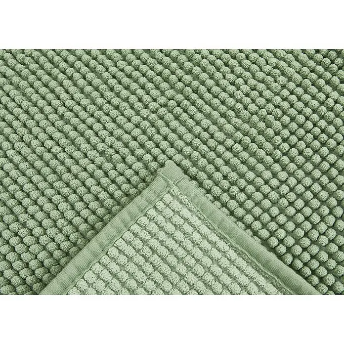 Badteppich Zottel - 50 x 80 cm, Salbei, 100% Polyester - Hellgrüne Badematte mit genoppter Struktur, eine gefaltete Ecke ist sichtbar.