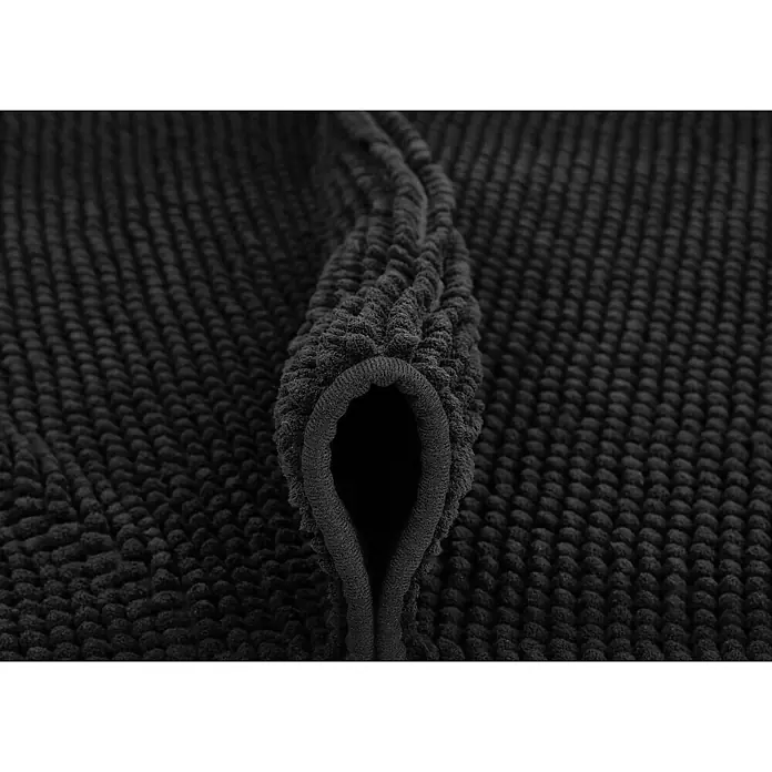 Badteppich Zottel - 50 x 80 cm, Schwarz, 100% Polyester - Nahaufnahme einer gefalteten schwarzen Badematte mit tiefer, saugfähiger, Noppen-ähnlicher Textur.
