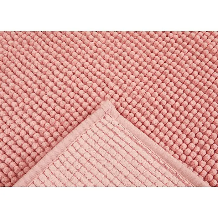 Badteppich Zottel - 50 x 80 cm, Rose, 100% Polyester - Rosa Badematte mit Noppenstruktur, eine Ecke umgeklappt, um die Rückseite zu zeigen.