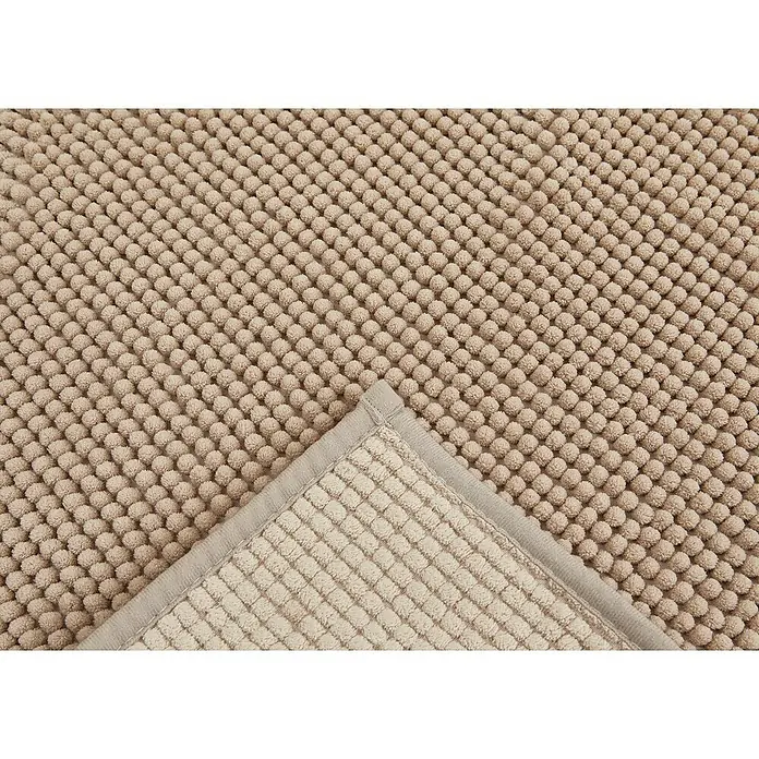 Badteppich Zottel - 50 x 80 cm, Sand, 100% Polyester - Beige strukturierte Matte mit Noppenoberfläche, Ecke umgeklappt, um gerippte Unterseite zu zeigen.