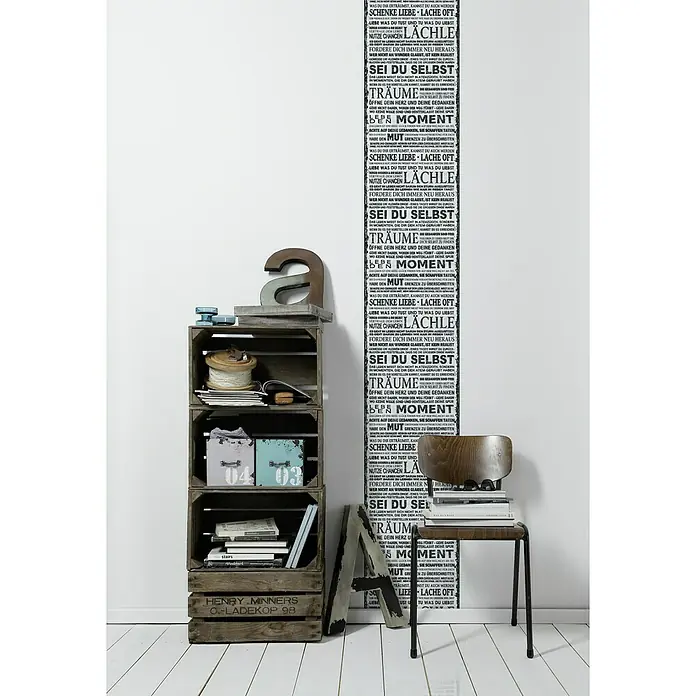 A.S. Création Designpanel pop.up - Motivation, Schwarz/Weiß, 35 cm x 2,5 m - Dekoratives Wohnambiente mit einem Holzregal, einem Stuhl mit Büchern und einer Wand mit inspirierenden Zitaten.