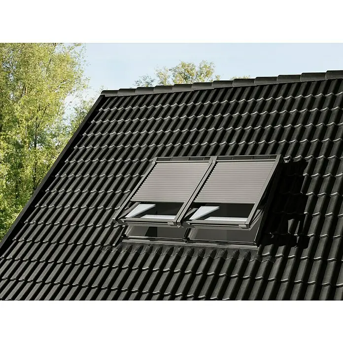 Velux Dachfenster-Rollladen Solar SSL CK06 0000K - Passend für Fenstergröße: CK06, C06, Passend für Fenstertyp: GGL, GGU, GPL, GPU, GHL, GHU, GZL, GLL, GLU, VU und VKU - Zwei graue Dachfenster mit geschlossenen Rollläden auf einem dunklen Ziegeldach.