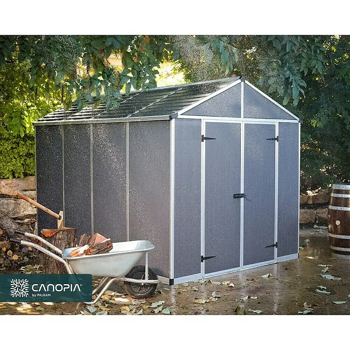 Palram – Canopia Gartenhaus Rubicon - Außenmaß inkl. Dachüberstand (B x T): 237,1 x 3,03 m, Kunststoff, Grau - Dunkelgrauer Gartenhaus mit stabilem Rahmen und lichtdurchlässigem Dach, im Freien mit Gartengeräten und sichtbaren Wassertropfen.