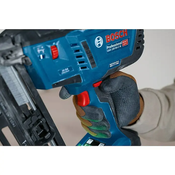 Bosch Professional Akku-Nagler GNH 18V-64-2 M PRO SOLO - 18 V, Ohne Akku, Länge Nagel: 32 mm - 64 mm - Blauer Bosch Nagler mit rotem Abzug, gehalten von einer behandschuhten Hand, zeigt professionelle Merkmale.