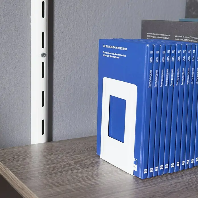 Element System Bücherstütze - 12 x 13 cm, Weiß, 1 Stk. - Nahaufnahme des blauen Temperguss-Ordners, der im Regal steht, mit weißem Einsatz und diversen Texten auf dem Rücken.