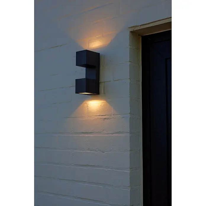 Lutec Aplique para exterior LED Fari - 10 W, L x An x Al: 92 x 65 x 193 mm, Gris oscuro, Aluminio, IP54 - Aplique de pared rectangular gris oscuro, proyectando luz cálida hacia arriba y abajo sobre una pared texturizada.