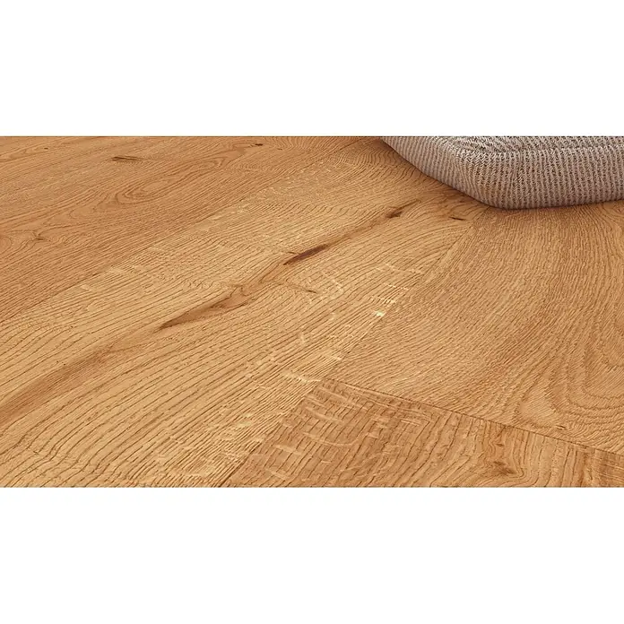 Barlinek Parkett - Eiche leichtbraun gebürstet, Landhausdiele, 1.092 x 180 x 14 mm - Heller Holzfußboden mit ausgeprägter Maserung und Ästen, teilweise von einem strukturierten grauen Objekt bedeckt.