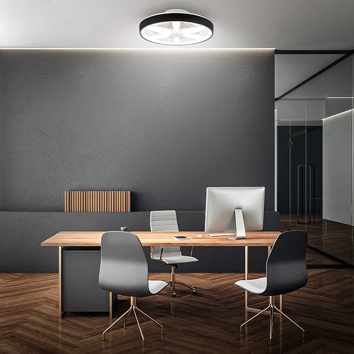 Briloner Ventilador de techo Air - Negro, 48 cm, 48,5 W, RGB - Lámpara de techo circular con marco negro y difusor en forma de estrella en una oficina moderna.
