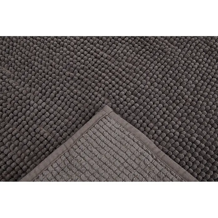 Badteppich Zottel - 50 x 80 cm, Anthrazit, 100% Polyester - Graue Badematte mit Noppenstruktur. Eine Ecke ist umgeschlagen und zeigt eine flache, gestreifte Unterseite und einen glatten Rand.