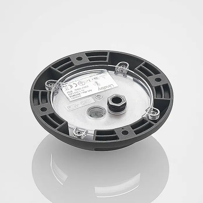 Lindby LED-Gartenstrahler Huban - 3.000 K - Runder, dunkelgrauer Außensockel für Leuchten mit klarer Abdeckung, die interne Verkabelungsanschlüsse und ein Spezifikationsetikett zeigt.