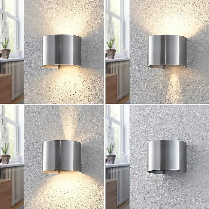 Arcchio Wandleuchte Zuzana - alu / grau / zink, G9 - Silber gebürstete Metall-Zylinder-Wandleuchte, die warmes Licht nach oben und unten auf eine strukturierte Wand wirft.