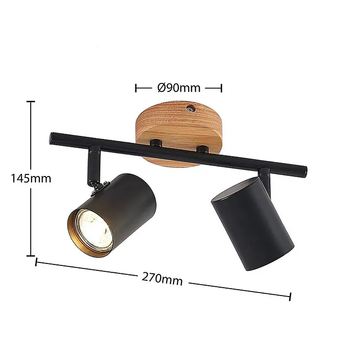 Lindby Deckenleuchte Xiomara - Holz hell, schwarz, GU10 - Zwei schwarze Deckenstrahler an einer schwarzen Stange mit rundem Holzsockel, ein Licht leuchtet.