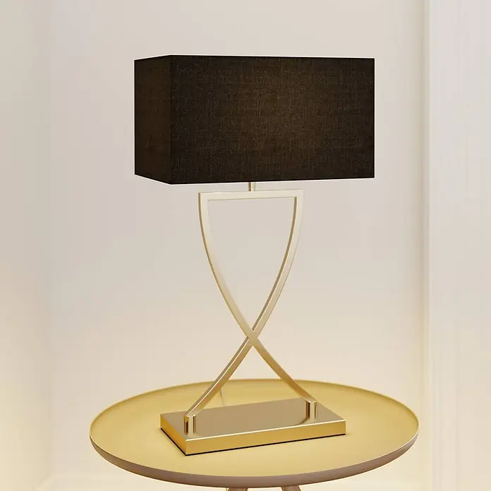 Lucande Tischleuchte Evaine - messing / gold, schwarz, E27 - Goldene Metall-Tischlampe mit schwarzem rechteckigem Stoffschirm, auf einem goldenen runden Tisch.