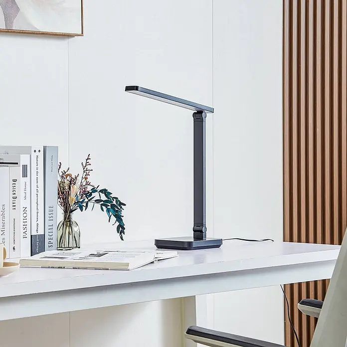 Lindby Tischleuchte Rylas - schwarz, schwarz - Schlanke dunkelgraue LED-Schreibtischlampe auf weißem Schreibtisch, ideal für konzentrierte Beleuchtung.