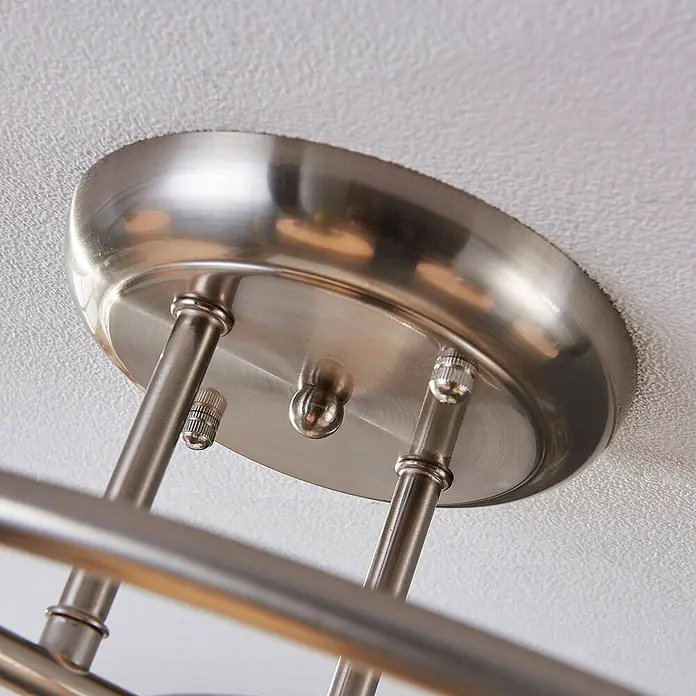 Lindby Deckenleuchte Svean - alu / grau / zink, E14 - Gebürstete Nickel-Deckenhalterung für Leuchte an einer strukturierten Decke mit Metallstäben.