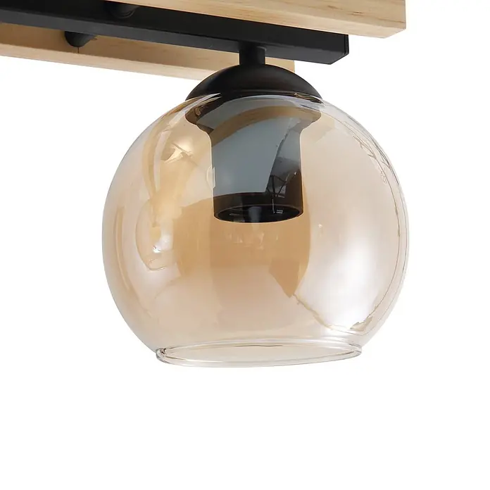 Lindby Deckenleuchte Enrique - schwarz, creme / amber, E27 - Leuchte mit Holzbalken, schwarzem Metallfuß und kugelförmigem, bernsteinfarbenem Glasschirm mit sichtbarer Glühbirne.