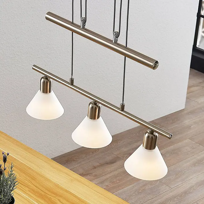 Lindby Pendelleuchte Delira - L x B x H: 54 x 12,5 x 14,5 cm, weiß, nickel satiniert, E14 - Pendelleuchte aus gebürstetem Metall mit drei konischen satinierten Glasschirmen über einem Holztisch.