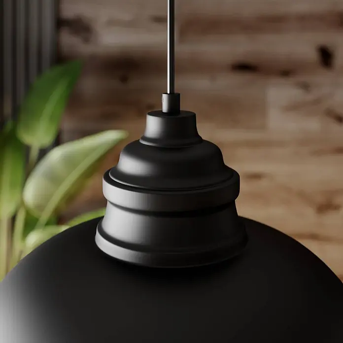 Lindby Pendelleuchte in schwarz matt, weiß, Hängelampe -  - Schwarze matte Pendelleuchte hängt in einem Raum mit Holzwand und Grünpflanze.