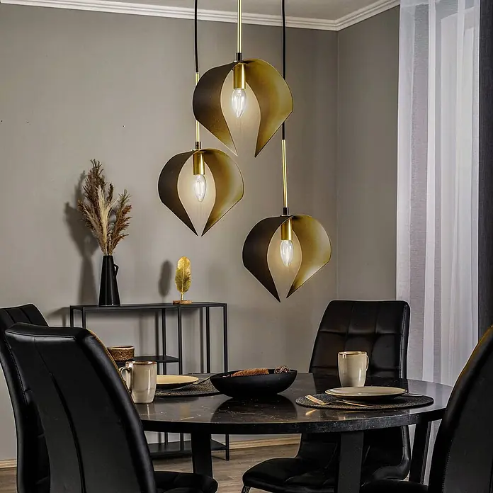 Lucande Pendelleuchte Mikolay - L x B x H: 51 x 51 x 150 cm, schwarz, sandSchwarz, E14 - Drei schwarz-goldene blattförmige Pendelleuchten hängen über einem dunklen Esstisch.