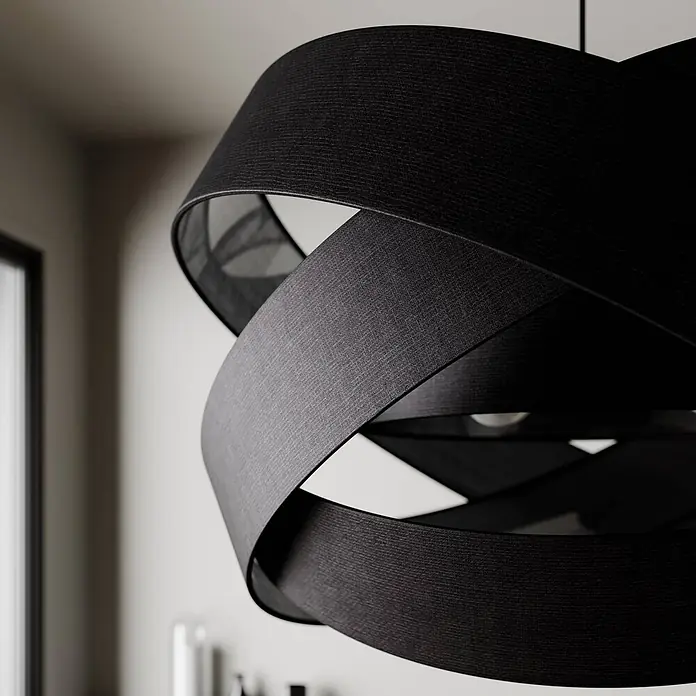 Lindby Pendelleuchte Simaria - schwarz, Schwarz, E27 - Nahaufnahme einer schwarzen, strukturierten Stoff-Pendelleuchte mit verschlungenem, geschichtetem Design, die in einem Raum hängt.