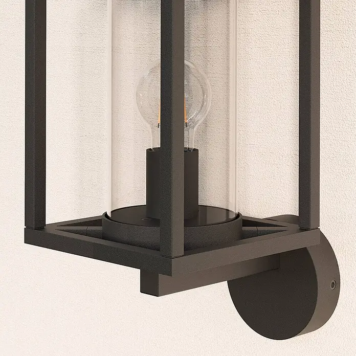 Lucande Außenwandleuchte Ferda - schwarz, schwarz, IP44 - Dunkle Metall-Außenwandleuchte mit klarem Glaszylinder und sichtbarer Glühbirne.