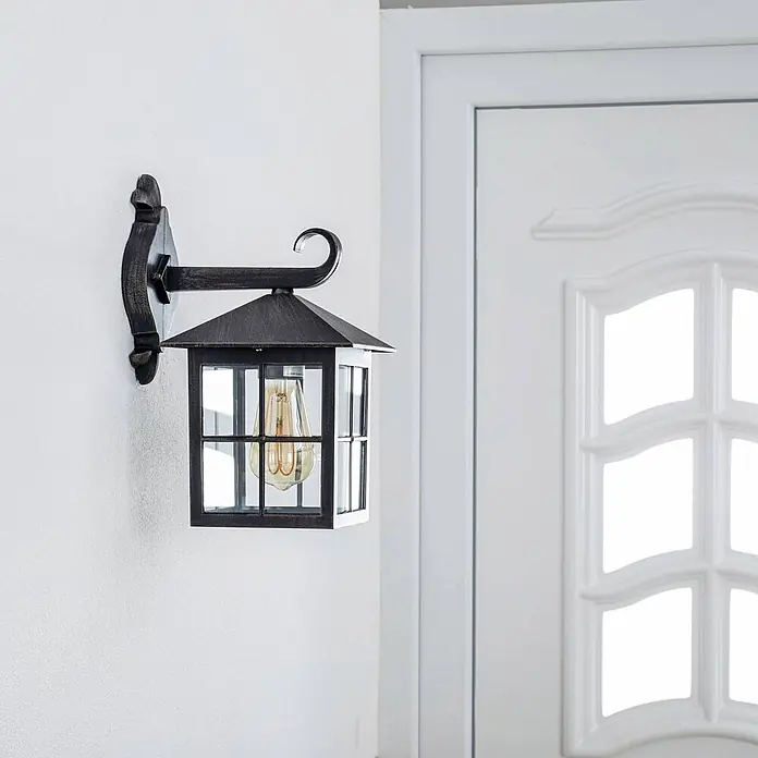 Lindby Außenwandleuchte Ida - braun / rost, braun / rost, IP23 - Eine Wandleuchte im Vintage-Stil aus dunklem Metall mit Klarglas und einer Edison-Glühbirne.