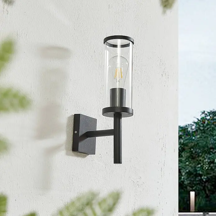 Lucande Außenwandleuchte Zanta - schwarz, klar / transparent, IP54 - Schwarze Außenwandleuchte mit klarem Glaszylinder und sichtbarer LED-Glühbirne.